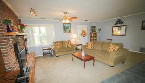 a living room with two couches and a tv at 15 Minutes to the Gulf of Mexico! Beautiful home on Lake Rousseau in Dunnellon