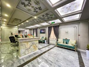 a large room with a ceiling with skylights at Medina Hotel Samarkand in Samarkand