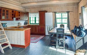 a kitchen with wooden cabinets and a table and a refrigerator at Lovely Home In Hemsedal With Wifi in Hemsedal