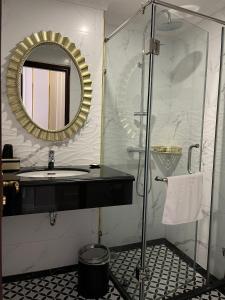 a bathroom with a sink and a mirror at CAT BA ROSALIA HOTEL in Cat Ba