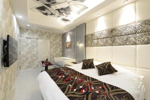 1 Schlafzimmer mit einem großen Bett und einem Badezimmer in der Unterkunft Hotel S-CUBE (Adult Only) in Bando