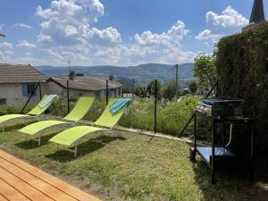 a group of green chairs and a grill in a yard at Maison rénovée avec jardin, BBQ, animaux acceptés - FR-1-489-341 in La Chabanne