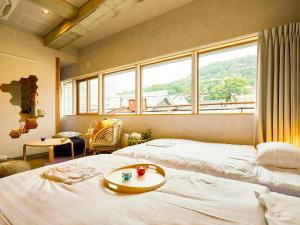 Una cama o camas en una habitación de Mange Tak Resort Onomichi