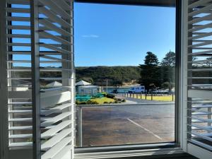 a window with a view of a parking lot at Southern Ocean Motor Inn in Port Campbell