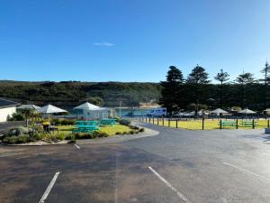 a parking lot with a view of a beach at Southern Ocean Motor Inn in Port Campbell