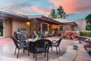 a patio with chairs and a table and a grill at PRIME Uptown Location- Mountain View- Kid Friendly - Sleeps 10 in Sedona