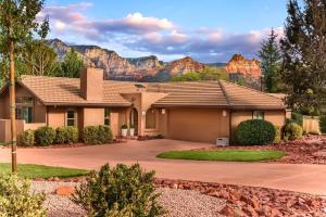 a house with a mountain in the background at PRIME Uptown Location- Mountain View- Kid Friendly - Sleeps 10 in Sedona