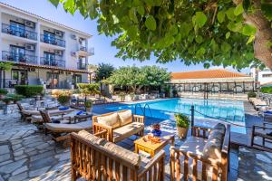 a hotel with a swimming pool and a resort at Ionia Hotel in Skopelos Town