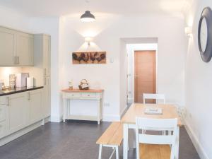 a kitchen and dining room with a table and chairs at Dairy Cottage - Uk39522 in Maybole