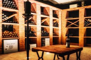 a wine cellar with a wooden table and wine bottles at Haus Zauberflöte in Offenburg