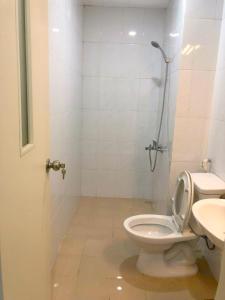 a bathroom with a toilet and a shower and a sink at Ha Long Homestay in Ha Long