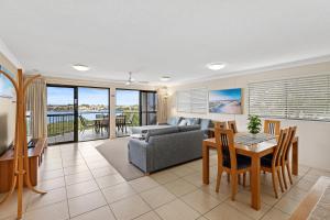 a living room with a couch and a table at Riverdance Apartments in Mooloolaba
