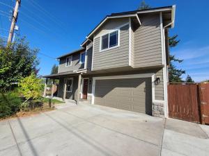 a house with a garage on a driveway at Spacious and peaceful 4 bedroom home in Everett