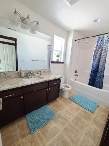 a bathroom with a sink and a toilet and a mirror at Spacious and peaceful 4 bedroom home in Everett