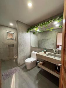 a bathroom with a toilet and a sink at SAMADHI Resort & Hydrospa Panglao in Panglao