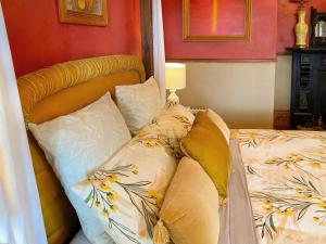 a bedroom with a bed with pillows on it at Tracy's Boutique B&B Farmstay in Wellsford