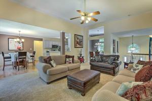 a living room with couches and a dining room at Peaceful Dallas Home with Deck and Charcoal Grill in Hiram
