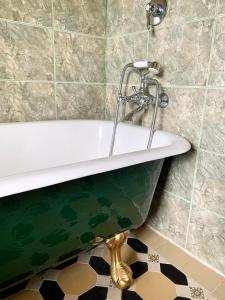 a bath tub with a faucet in a bathroom at Tracy's Boutique B&B Farmstay in Wellsford