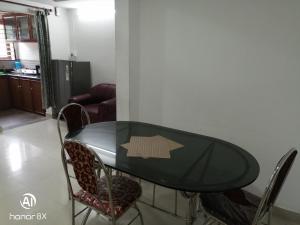 a table and chairs in a room with a kitchen at B & B Konni, Pathanamthitta in Pathanāmthitta
