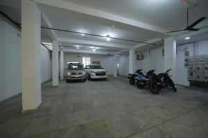 a garage with cars and motorcycles parked in it at Nadanam Inn in Puducherry