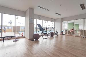a gym with treadmills and exercise equipment in a building at RedLiving Apartemen Mekarwangi Square - M Express in Bandung