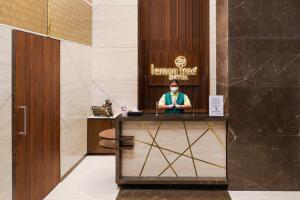 a man sitting at a desk in a lobby at Lemon Tree Hotel, Kalina, Mumbai in Mumbai