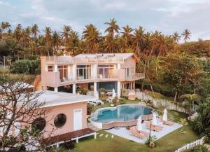 an aerial view of a house with a swimming pool at Belika Beach in Hiriketiya