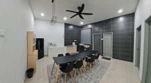 a dining room with a black table and chairs at AYA HOMESTAY BANDAR MELAKA in Melaka