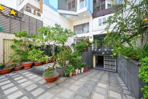 a courtyard of a building with potted plants at Quang Hoa Airport Hotel in Ho Chi Minh City
