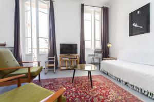 1 dormitorio con cama, mesa y sofá en Appartement le Fighiéra, en Niza