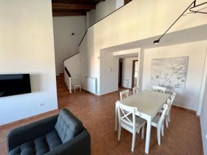 a living room with a table and chairs and a couch at GOLF SOJUELA naturaleza Pet friendly in Sojuela