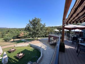 a deck with tables and chairs and a park at GOLF SOJUELA naturaleza Pet friendly in Sojuela