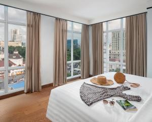 a hotel room with a bed with a view of a city at The Reiz Suites, ARTOTEL Curated in Medan