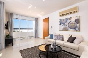 a living room with a couch and a table at The Saline Views Makenzy in Larnaca