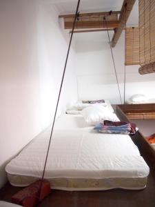 two beds hanging from a ceiling with ropes at Project Uchi SS2 in Petaling Jaya