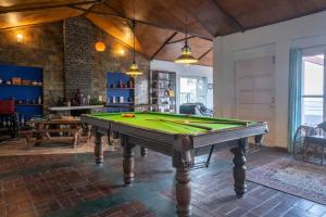 a pool table in the middle of a room at Misty Mountains Cottage - In the Lap of Nature! in Kasauli