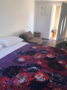 a bedroom with a bed with a colorful rug on it at Apartments Tonka in Zadar