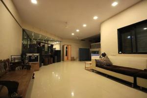 a large living room with a couch and a tv at Oxygen 2 Villa Khopoli in Khopoli