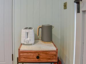 a toaster sitting on top of a wooden table at Shepherds Beachhouse in Pagham