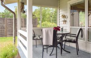 a screened in porch with a table and chairs at Awesome Home In Oskarshamn With 1 Bedrooms And Wifi in Oskarshamn