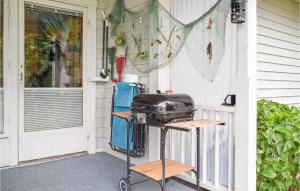 a grill on the porch of a house at Awesome Home In Oskarshamn With 1 Bedrooms And Wifi in Oskarshamn