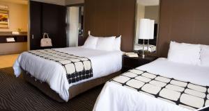 a hotel room with two beds with white sheets at Hotel Marshfield, BW Premier Collection in Marshfield