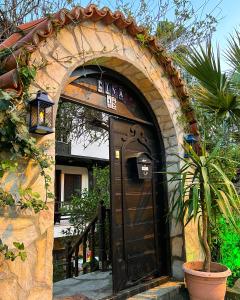 an entrance to a house with a black door at Liya Boutique Hotel & Suites in Akyaka
