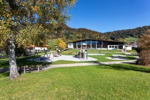 um parque com parque infantil em frente a um edifício em Steinplatte em Reit im Winkl