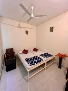 two beds in a room with a ceiling fan at Hostel ivory in Jaipur