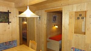 a room with wooden walls and a small room with a table at Appartement Agostini in Sölden