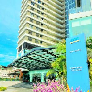 a building with a sign in front of it at FLC Sea Tower Quy Nhon -Tran Apartment in Quy Nhon
