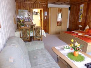 a living room with a couch and a bed at Ferienhaus Weber Bad Frankenhausen in Bad Frankenhausen