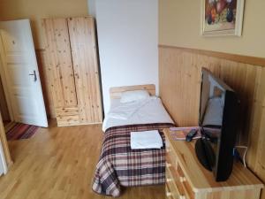 a bedroom with a bed and a desk with a tv at Paide B&B in Paide