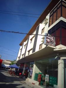 a building with a sign in front of it at WJV INN CASUNTINGAN in Mandaue City